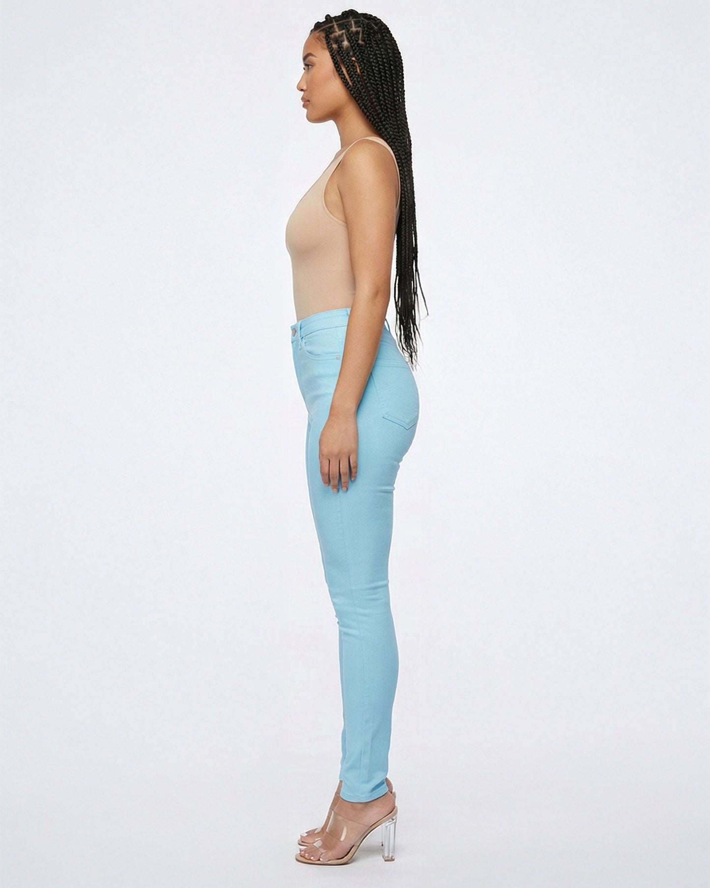 Side view of light blue skinny jeans showing the fit on model