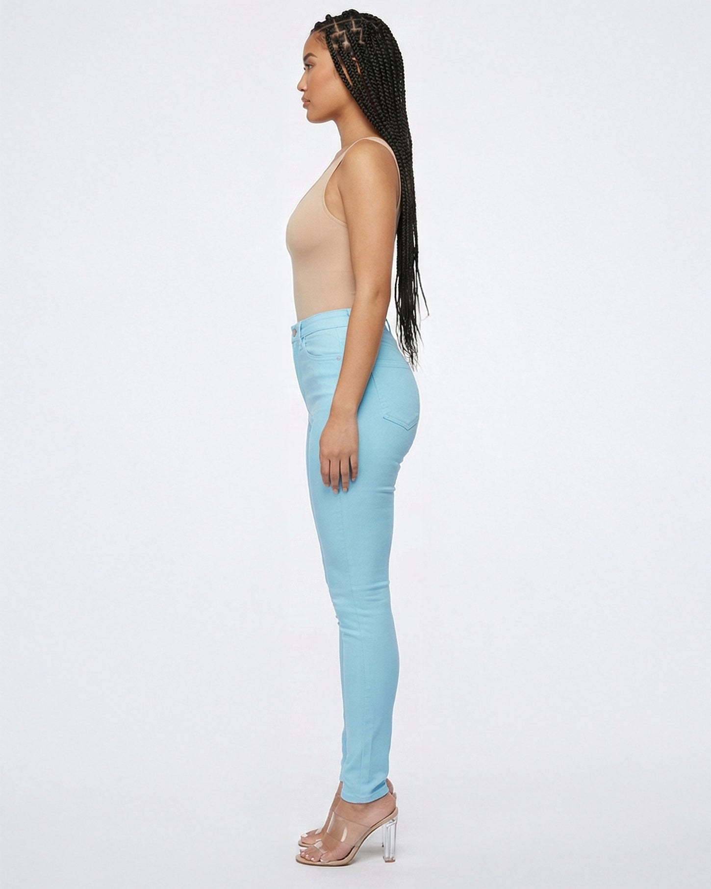 Side view of light blue skinny jeans showing the fit on model