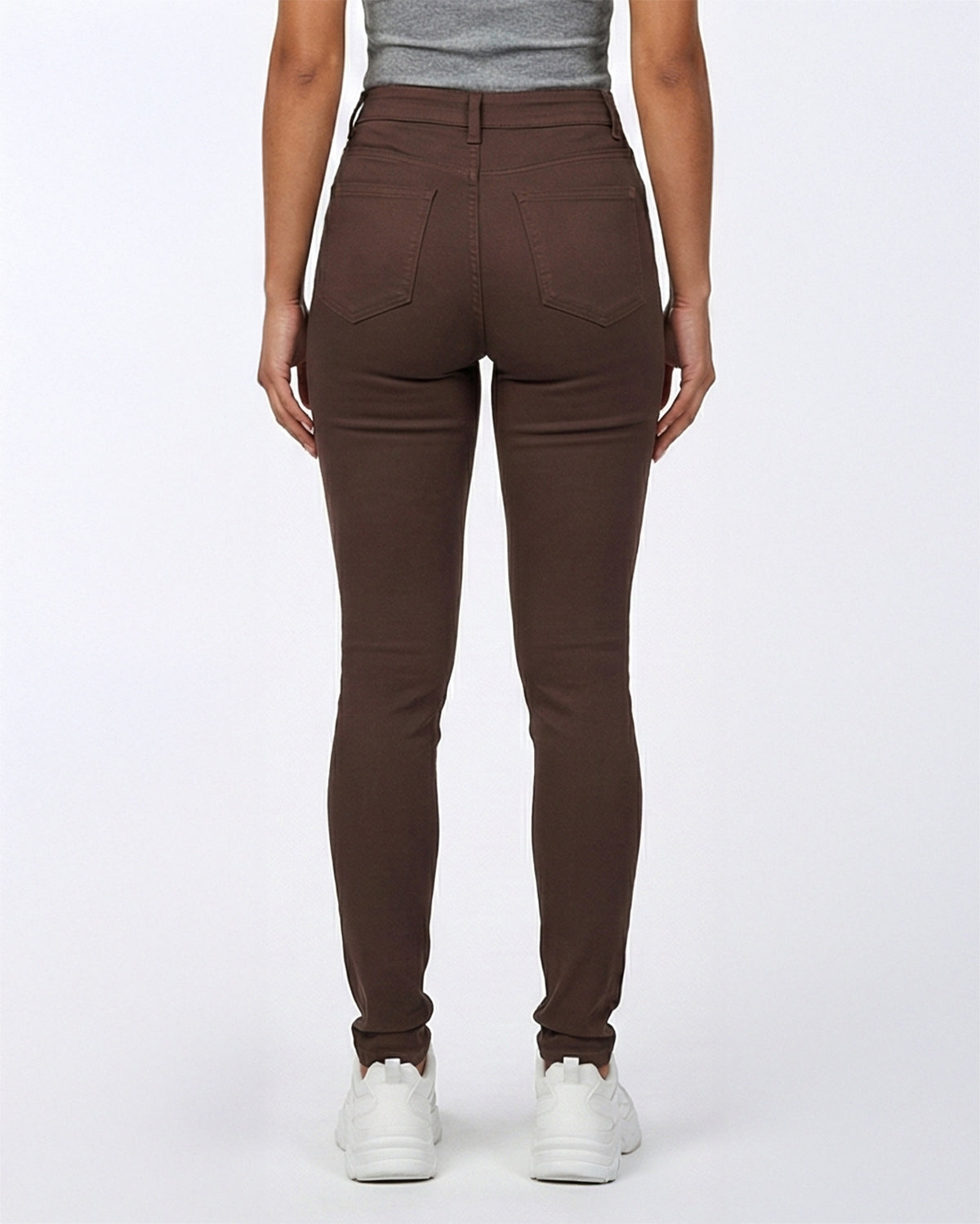 Back view of brown stretch skinny jeans on a model