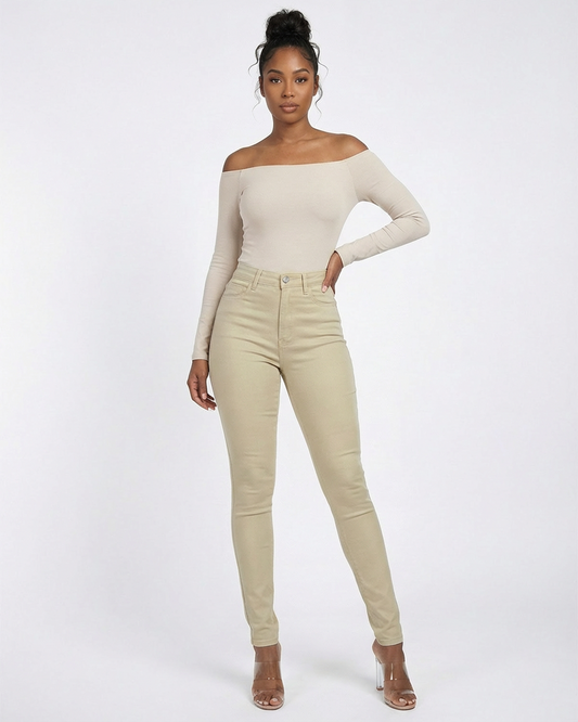 Woman wearing a beige off-shoulder top and khaki pants on a white background