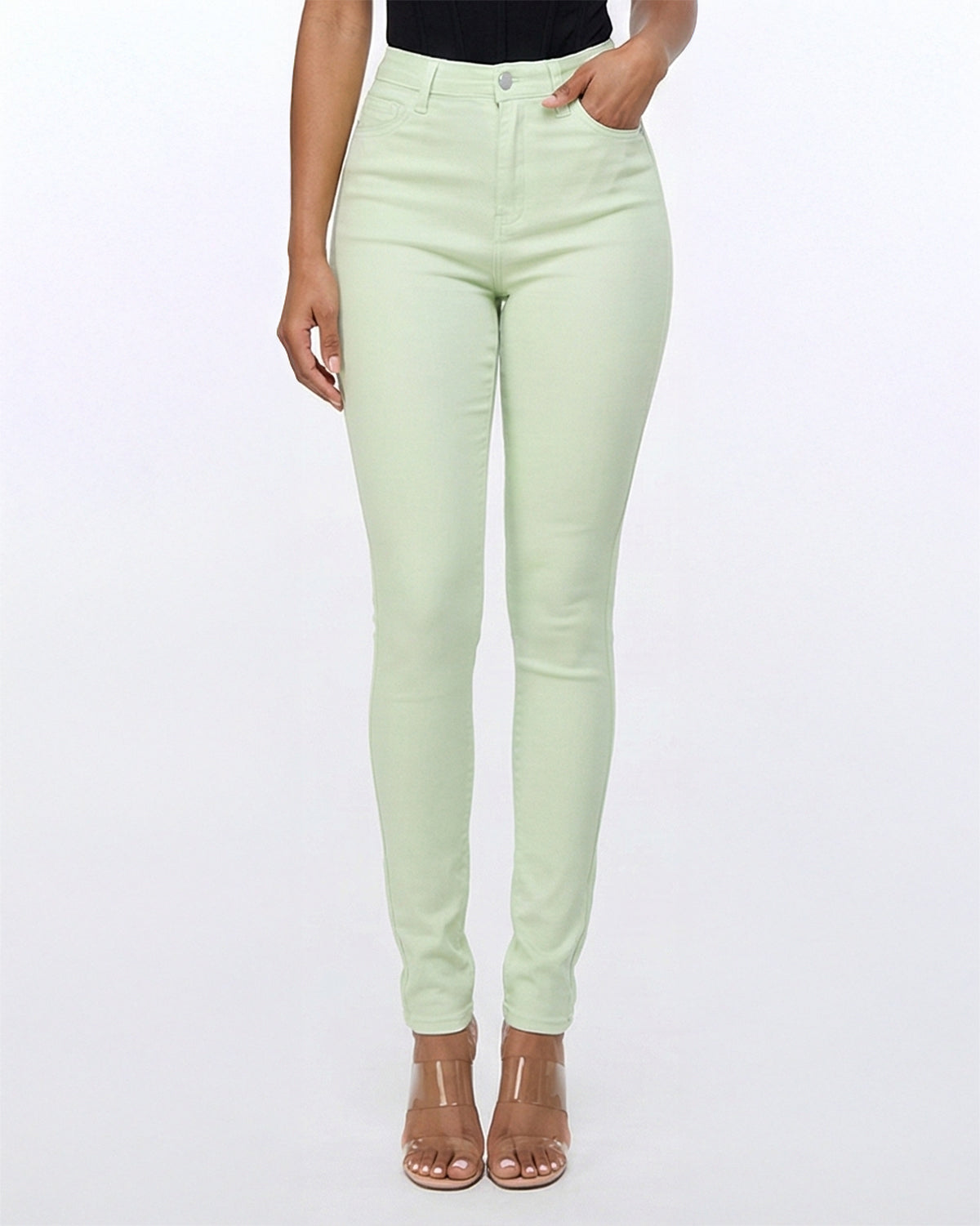 Close up angle of light green skinny jeans showing front pocket and stitching