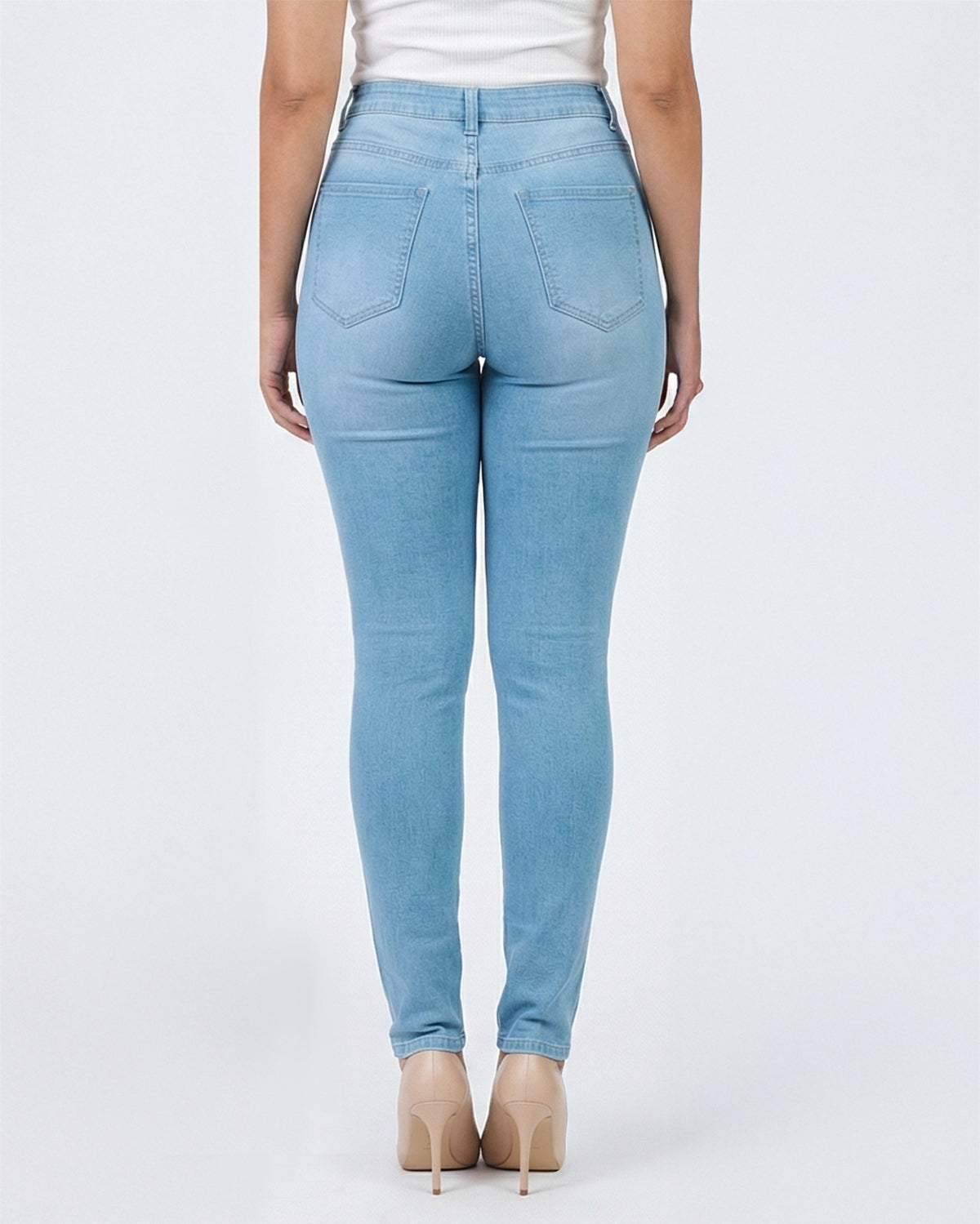 Back view of light blue wash skinny jeans on a model