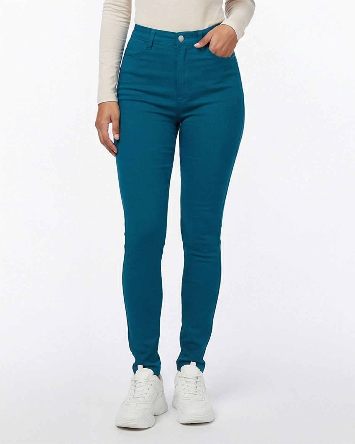 Detail view of deep teal skinny jeans showing front pocket and stitching