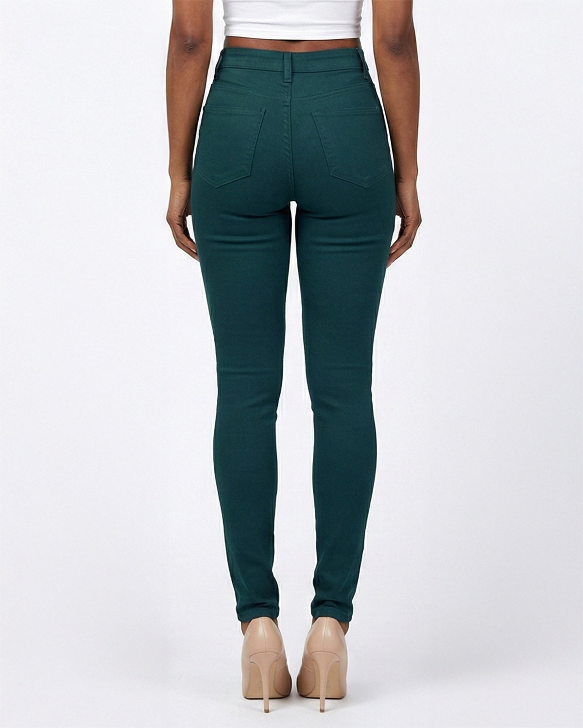 Back view of dark green stretch skinny jeans on a model