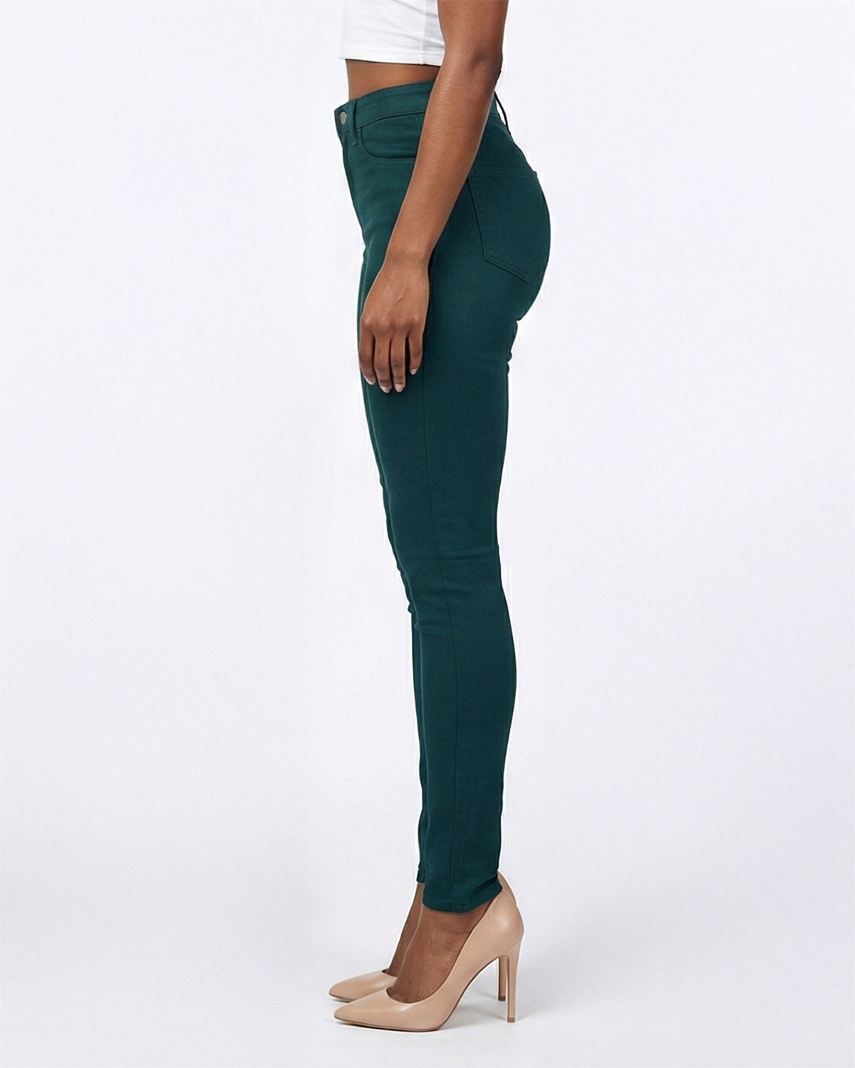 Model wearing dark green stretch skinny jeans, side angle showing fit