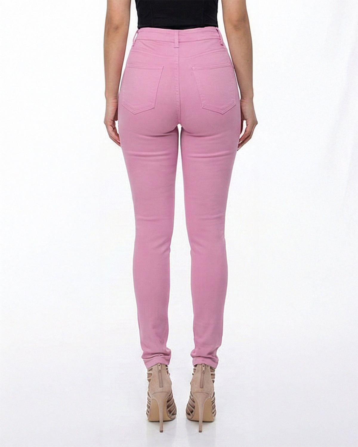Back view of pink stretch skinny jeans on a model