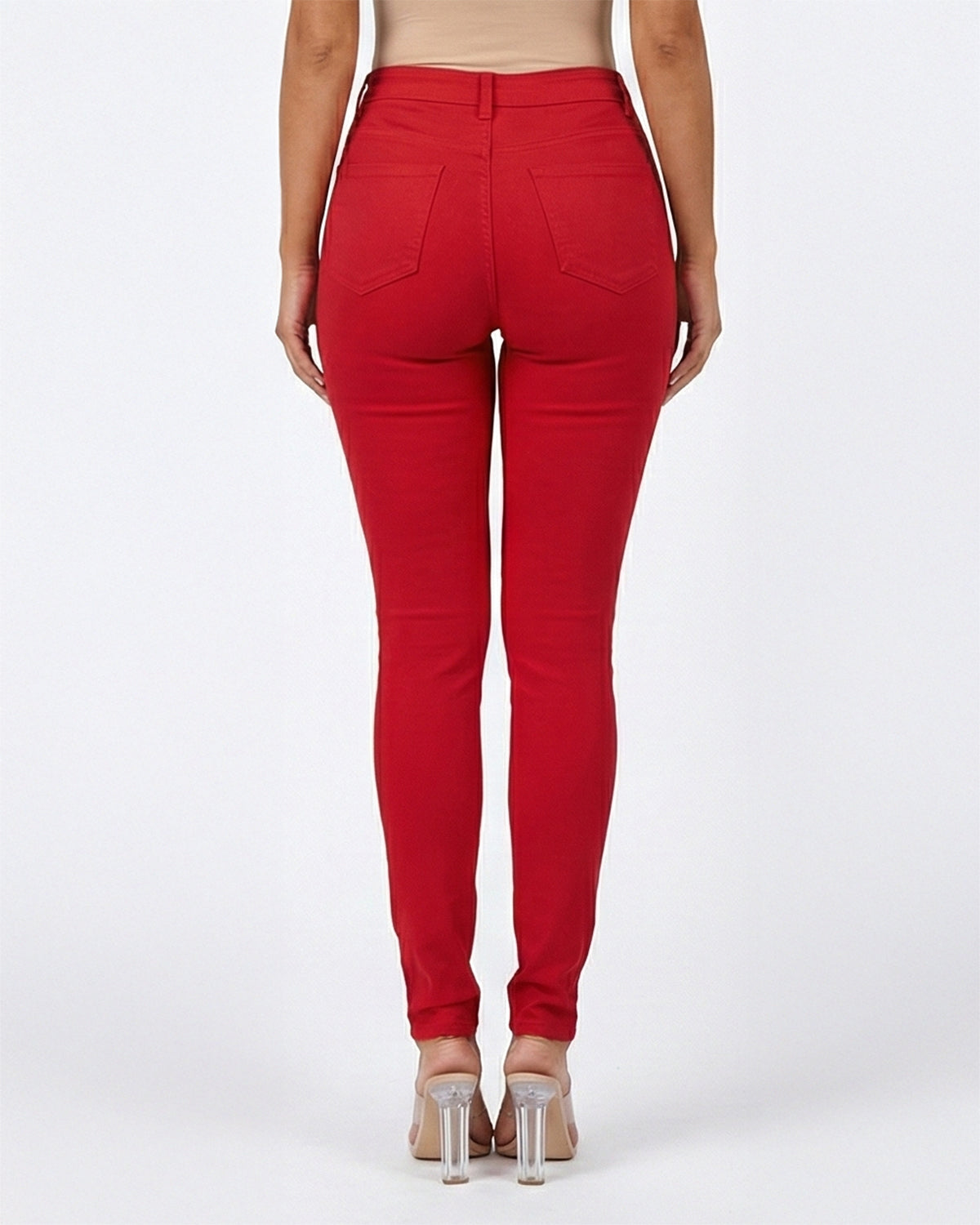 Back view of red stretch skinny jeans on a model