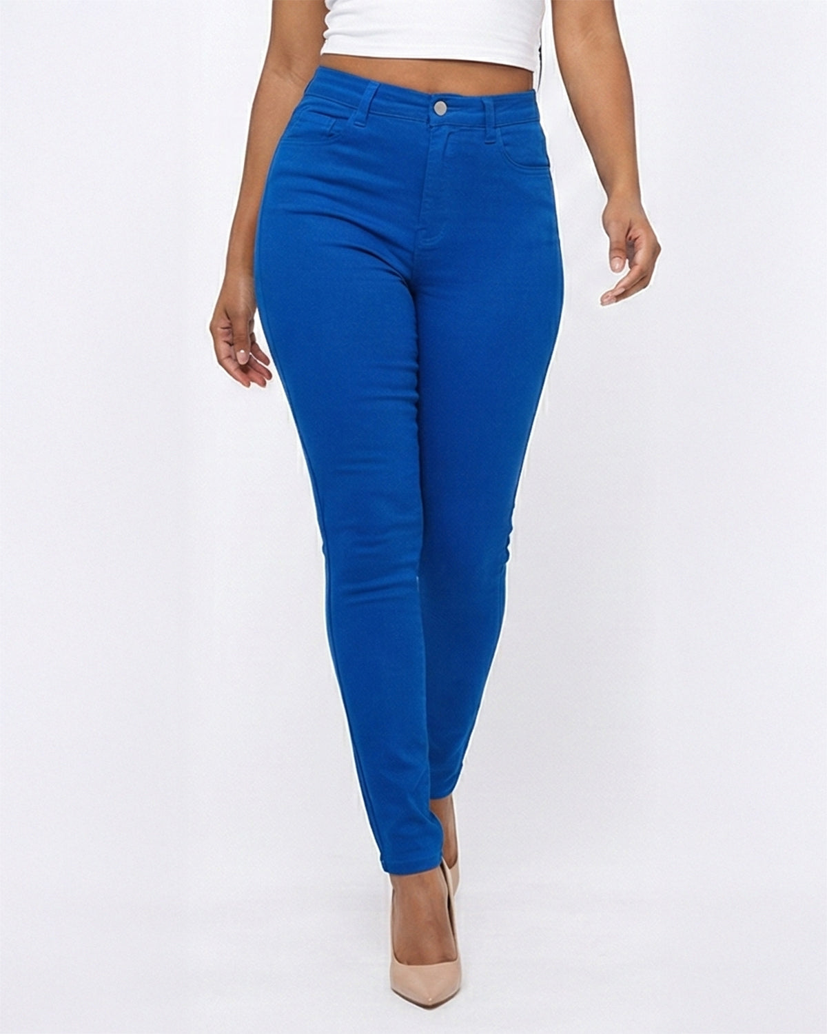 Close up view of model wearing blue skinny jeans on a white background
