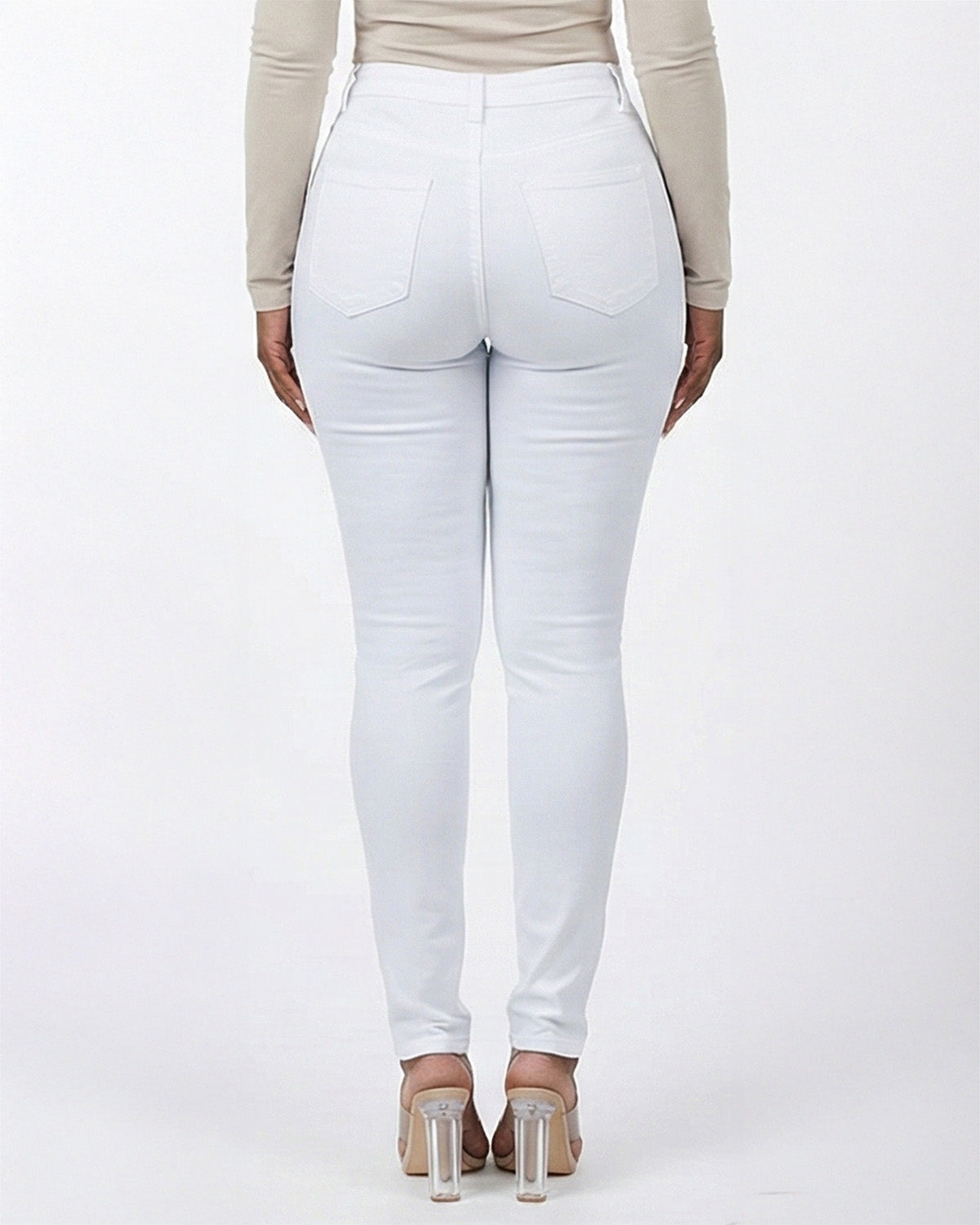 Back view of white stretch skinny jeans on a model