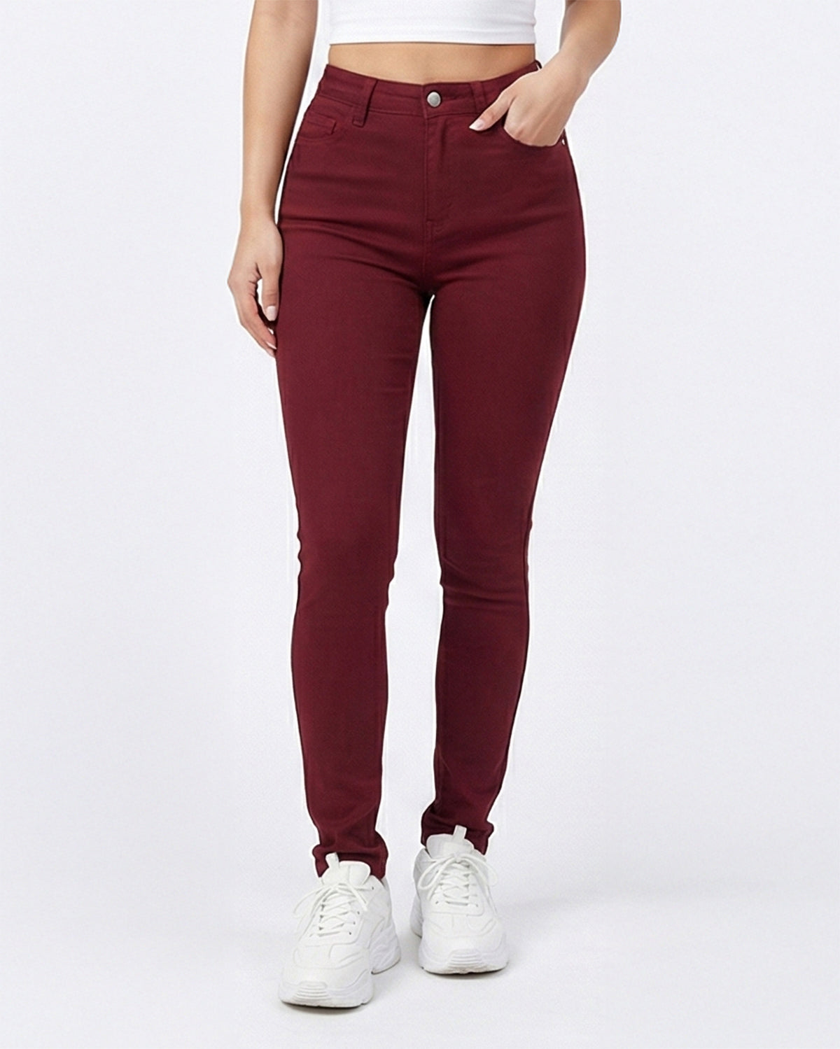 Detail front view of maroon skinny jeans worn by model