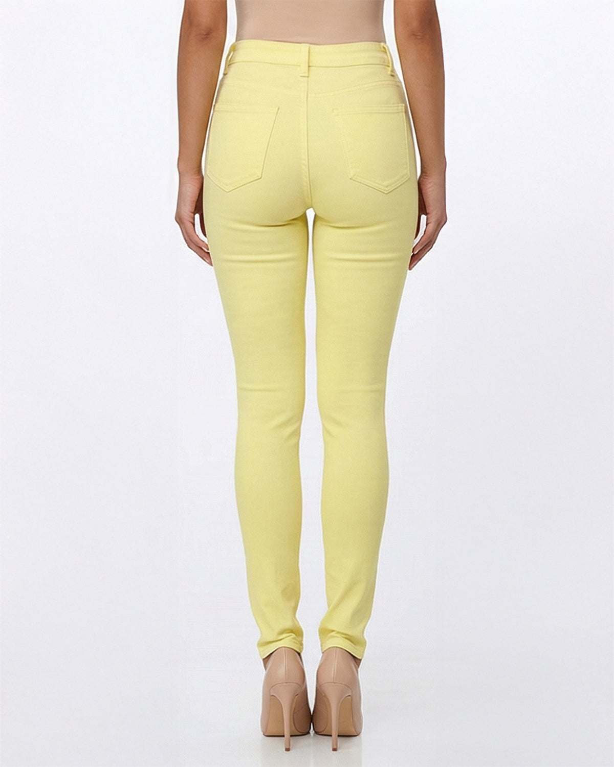 Back view of yellow stretch skinny jeans on a model